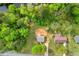 Aerial view of a cozy home nestled among lush green trees in a neighborhood setting at 1751 Riverside Dr, Hillsborough, NC 27278