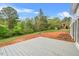 Spacious backyard with a wooden deck overlooking the natural landscape and trees at 1751 Riverside Dr, Hillsborough, NC 27278