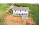 Spacious backyard featuring a sunroom with many windows and a wooden deck at 1751 Riverside Dr, Hillsborough, NC 27278
