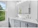 Bathroom featuring double sinks, stylish vanity, and large mirror at 1751 Riverside Dr, Hillsborough, NC 27278