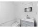 Simple bathroom featuring white fixtures, a light blue vanity, and neutral tones at 1751 Riverside Dr, Hillsborough, NC 27278