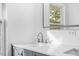 Bathroom featuring gray vanity, quartz countertop, and chrome faucet at 1751 Riverside Dr, Hillsborough, NC 27278