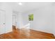 Bright bedroom with hardwood floors, white walls, and natural light at 1751 Riverside Dr, Hillsborough, NC 27278
