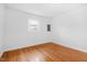 Empty bedroom with hardwood floors, white walls, and natural light at 1751 Riverside Dr, Hillsborough, NC 27278