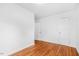 Empty bedroom with hardwood floors, white walls, and two doors at 1751 Riverside Dr, Hillsborough, NC 27278