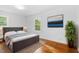 Cozy bedroom featuring a comfortable bed, area rug, and wood flooring at 1751 Riverside Dr, Hillsborough, NC 27278