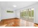 Large bedroom features hardwood floors, lots of natural light, and access to an enclosed patio at 1751 Riverside Dr, Hillsborough, NC 27278