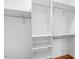 Spacious closet with white shelving and hanging rods for optimal organization at 1751 Riverside Dr, Hillsborough, NC 27278