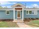Beautiful front entrance with a covered porch, attractive landscaping, and a well-maintained lawn at 1751 Riverside Dr, Hillsborough, NC 27278