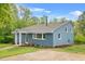 Charming two-story home with a brick exterior and landscaped yard showcasing a well-maintained lawn and colorful foliage at 1751 Riverside Dr, Hillsborough, NC 27278