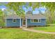 Lovely single-story home with blue brick exterior, manicured lawn, mature trees, and a welcoming front entrance at 1751 Riverside Dr, Hillsborough, NC 27278
