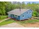 Charming blue two-story home with a well-maintained yard and classic architectural details at 1751 Riverside Dr, Hillsborough, NC 27278