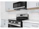 Modern kitchen featuring stainless steel appliances, light blue cabinets, and white subway tile backsplash at 1751 Riverside Dr, Hillsborough, NC 27278