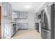 Kitchen with new stainless steel appliances, white subway tile, and gray cabinets at 1751 Riverside Dr, Hillsborough, NC 27278