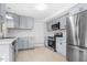 Modern kitchen featuring stainless steel appliances and gray cabinets at 1751 Riverside Dr, Hillsborough, NC 27278