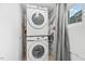 Laundry room featuring a stacked washer and dryer set with a view to the outdoors at 1751 Riverside Dr, Hillsborough, NC 27278
