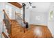 Elegant living area featuring hardwood floors, a cozy fireplace, and staircase leading to the upper floor at 1751 Riverside Dr, Hillsborough, NC 27278