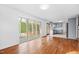 Living room with hardwood floors, sliding glass doors to a patio, and an attached kitchen at 1751 Riverside Dr, Hillsborough, NC 27278
