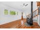 Inviting living area with a cozy fireplace, hardwood floors, and abundant natural light from the windows at 1751 Riverside Dr, Hillsborough, NC 27278