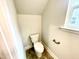 Clean, simple bathroom with toilet, window and towel rack at 177 Kipling Creek Dr, Fuquay Varina, NC 27526