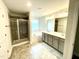 Modern bathroom with a walk-in shower, soaking tub, dual sink vanity, and excellent lighting at 177 Kipling Creek Dr, Fuquay Varina, NC 27526