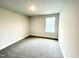 A bright bedroom with carpeting and a window offers comfort and style at 177 Kipling Creek Dr, Fuquay Varina, NC 27526