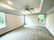 Spacious bedroom featuring plush carpeting, a ceiling fan, and abundant natural light from the windows at 177 Kipling Creek Dr, Fuquay Varina, NC 27526