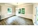 Dining room with chandelier, wainscoting, hardwood floors, and large windows at 177 Kipling Creek Dr, Fuquay Varina, NC 27526