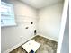 Well-lit laundry room with practical flooring and essential hookups at 177 Kipling Creek Dr, Fuquay Varina, NC 27526