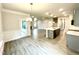 Open concept living space that leads to kitchen with island and pendant lighting at 177 Kipling Creek Dr, Fuquay Varina, NC 27526