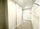 Long walk-in closet with wall to wall shelving and gray carpet at 177 Kipling Creek Dr, Fuquay Varina, NC 27526