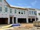 New construction townhome featuring a front-facing garage and multiple windows at 178 Nimble Way # 221, Clayton, NC 27520