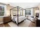 Luxurious main bedroom with a canopy bed, sitting area, and lots of natural light at 1805 Harrell Cove Ct # 180 Eldorado Fc, Fuquay Varina, NC 27526