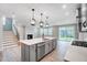 Modern kitchen featuring a spacious island, stainless steel appliances, and stylish pendant lighting at 1813 Harrell Cv Ct # 182 Voyageur Fc, Fuquay Varina, NC 27526