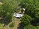 Aerial view showcases the home nestled among beautiful, mature trees at 1835 Pearidge Rd, Angier, NC 27501