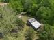 Aerial view of the property showing a large barn nestled among lush trees and greenery at 1835 Pearidge Rd, Angier, NC 27501