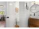 Bathroom featuring shiplap walls, a round mirror, and a decorative accent wall at 1835 Pearidge Rd, Angier, NC 27501