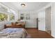 Bright bedroom with hardwood floors and two windows, complemented by a rustic desk and dresser at 1835 Pearidge Rd, Angier, NC 27501
