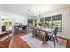 Bright dining area with a wooden table, bench seating, large windows, and stylish decor at 1835 Pearidge Rd, Angier, NC 27501