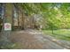 Private driveway leading to a gated entrance surrounded by beautiful, mature trees at 1835 Pearidge Rd, Angier, NC 27501