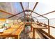 Inside of the greenhouse showing wooden tables for potting, shelves, and natural light at 1835 Pearidge Rd, Angier, NC 27501