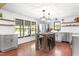 Bright kitchen features stainless steel appliances, wood floors, an island with stools, and modern light fixtures at 1835 Pearidge Rd, Angier, NC 27501
