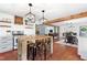 Spacious kitchen and dining area with wood floors, breakfast table, and open access to living room at 1835 Pearidge Rd, Angier, NC 27501
