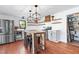 Bright kitchen features stainless steel appliances, a breakfast table, and stylish open shelving at 1835 Pearidge Rd, Angier, NC 27501
