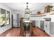 Open-concept kitchen features stainless steel appliances, wood floors, an island with stools, and farmhouse accents at 1835 Pearidge Rd, Angier, NC 27501