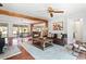 Open-concept living room with hardwood floors, comfortable seating, and views into the dining room at 1835 Pearidge Rd, Angier, NC 27501