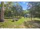 Lush yard with mature trees, a rustic outbuilding and a cozy hammock for relaxing at 1835 Pearidge Rd, Angier, NC 27501