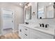 Bathroom featuring dual sinks, quartz countertops, modern fixtures, and a walk-in closet at 186 Gumtop Dr, Zebulon, NC 27597
