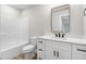 Bright bathroom with a large mirror, modern fixtures, and a bathtub with shower at 186 Gumtop Dr, Zebulon, NC 27597