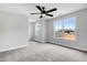 Large bedroom with plush carpeting, a ceiling fan, and views of the neighborhood at 186 Gumtop Dr, Zebulon, NC 27597